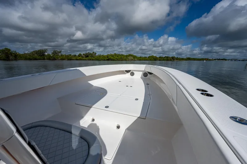  Yacht Photos Pics 2005 Venture 39 Open boat on calm water with cloudy sky.
