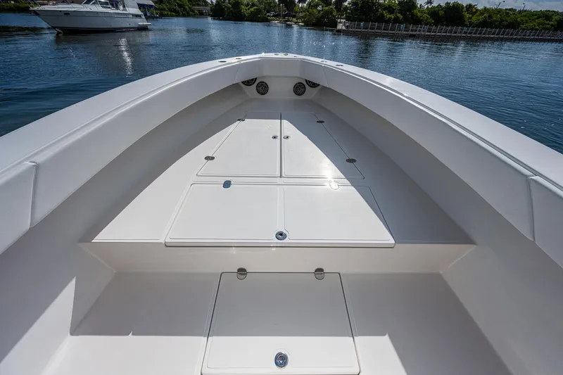  Yacht Photos Pics 2005 Venture 39 Open boat deck with storage compartments on calm water.