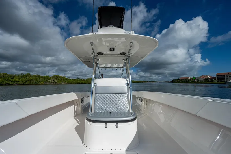  Yacht Photos Pics 2005 Venture 39 Open boat with center console and seating, on a calm waterway.