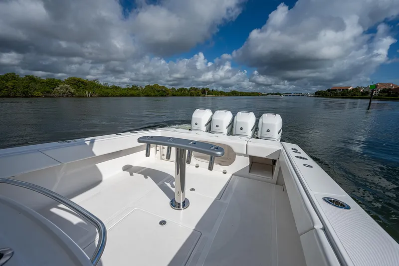  Yacht Photos Pics 2005 Venture 39 Open boat with quad outboard engines on a calm river.