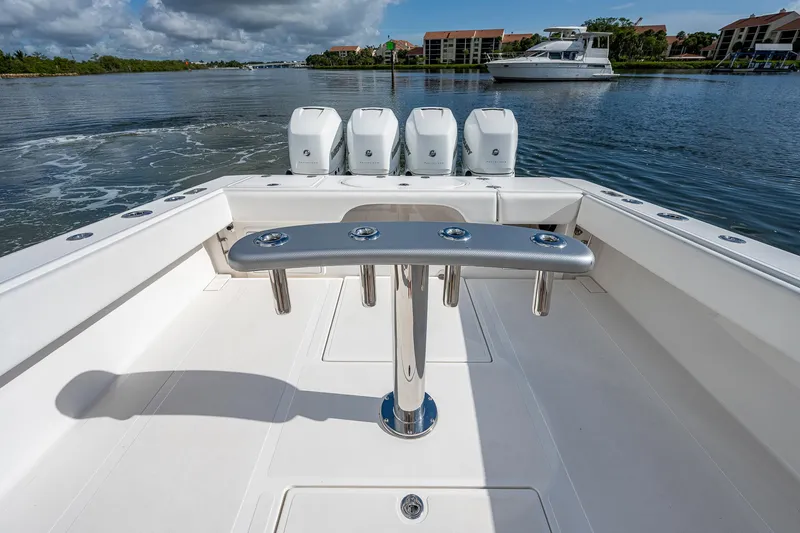  Yacht Photos Pics 2005 Venture 39 Open boat with quad outboard engines on a calm waterway.