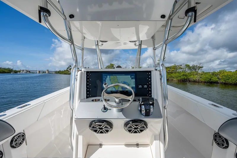  Yacht Photos Pics 2005 Venture 39 Open boat helm with steering wheel and navigation system.