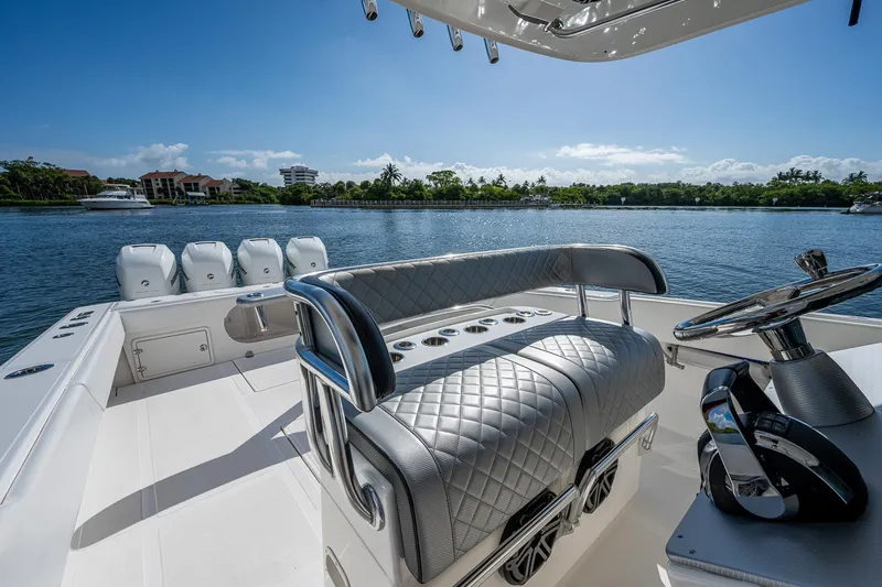  Yacht Photos Pics 2005 Venture 39 Open boat with luxurious seating and multiple outboard engines on a sunny day.