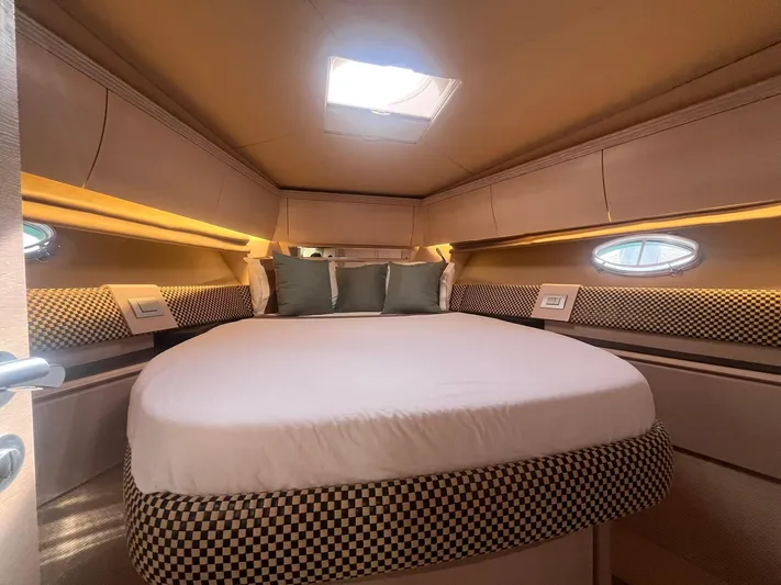  Yacht Photos Pics Luxurious bedroom interior of 2010 Atlantis 55 yacht with elegant bedding and ambient lighting.