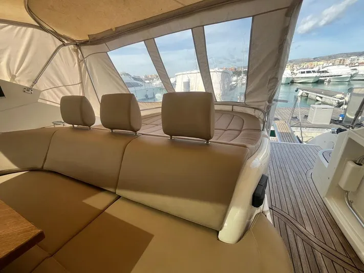  Yacht Photos Pics Luxurious 2010 Atlantis 55 yacht interior with beige seating and marina view.