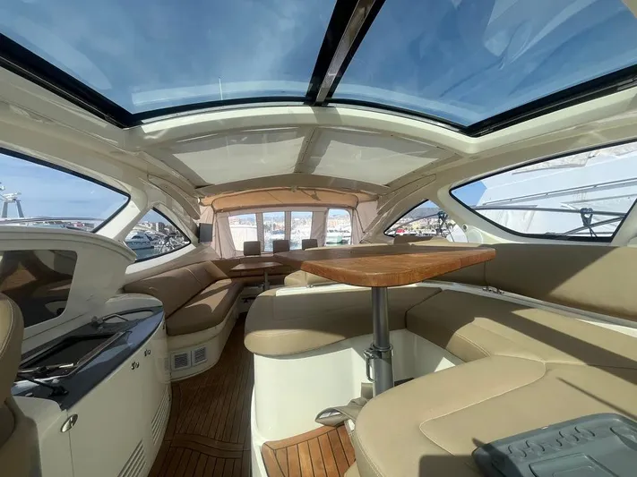  Yacht Photos Pics Luxurious interior of 2010 Atlantis 55 yacht with panoramic windows and elegant seating.