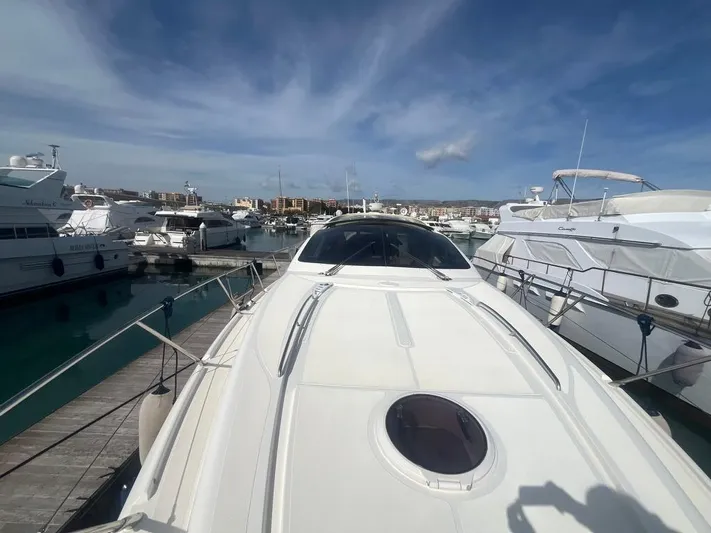  Yacht Photos Pics 2010 Atlantis 55 yacht docked at marina under clear blue sky.