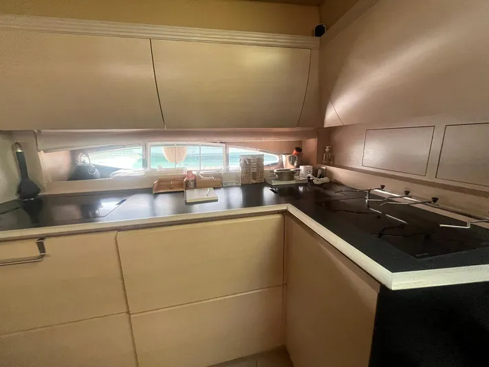  Yacht Photos Pics Modern kitchen interior on a 2010 Atlantis 55 yacht, featuring sleek cabinetry and appliances.