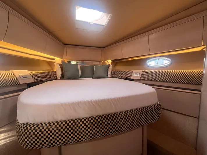  Yacht Photos Pics Luxurious cabin interior of 2010 Atlantis 55 yacht with elegant bedding and ambient lighting.