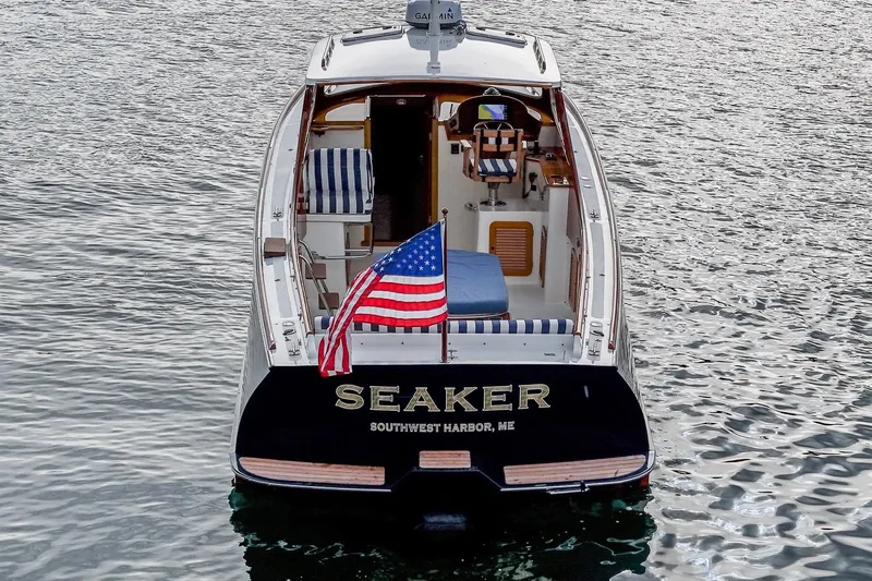Seaker Yacht Photos Pics 2001 Hinckley Picnic Boat Classic on water, American flag, Southwest Harbor, ME.