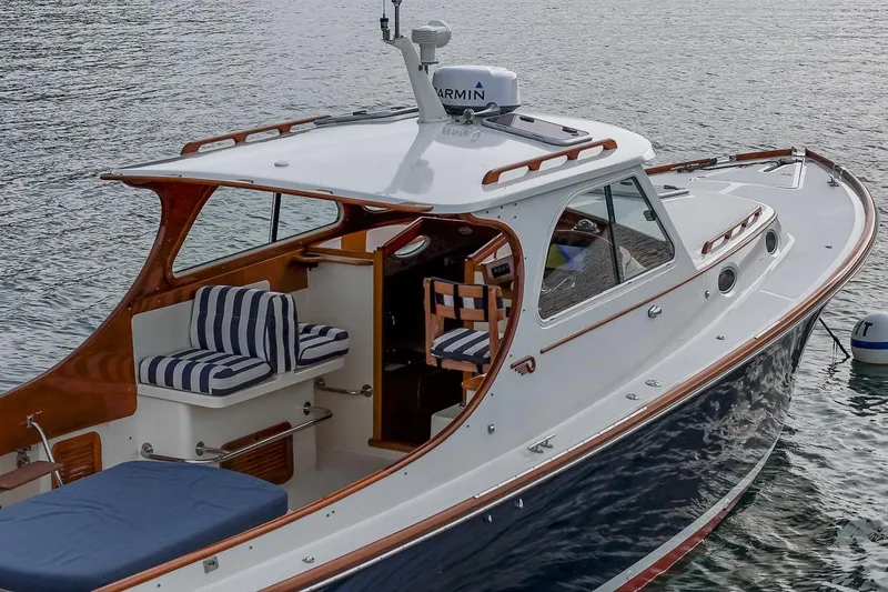 Seaker Yacht Photos Pics 2001 Hinckley Picnic Boat Classic on water, featuring elegant design and striped seating.