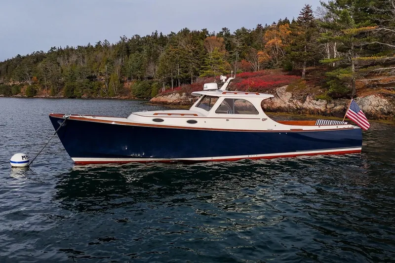 Seaker Yacht Photos Pics 2001 Hinckley Picnic Boat Classic moored on scenic water with forested shoreline.