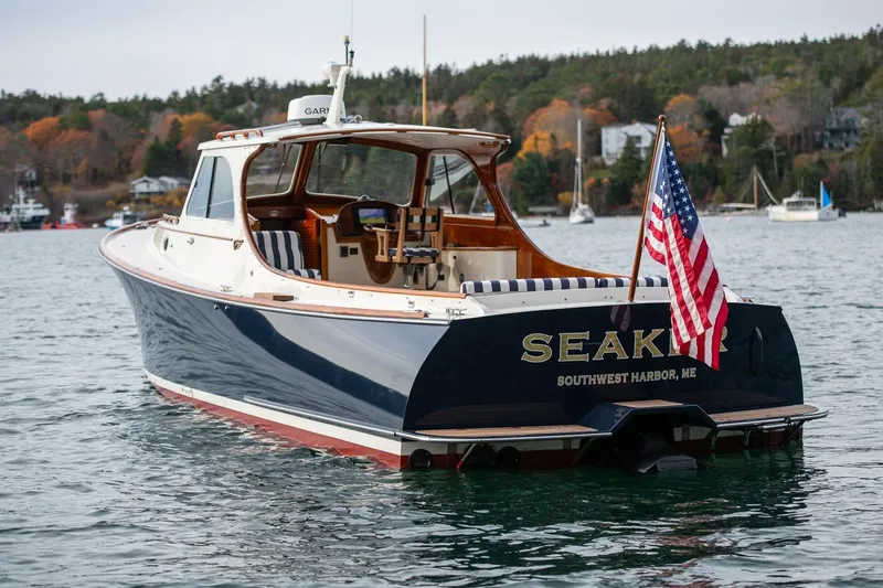 Seaker Yacht Photos Pics 2001 Hinckley Picnic Boat Classic on water, American flag, Southwest Harbor, Maine.