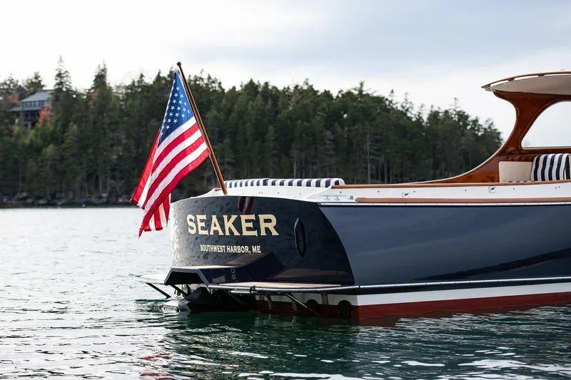 Seaker Yacht Photos Pics 2001 Hinckley Picnic Boat Classic with American flag, Southwest Harbor, Maine.