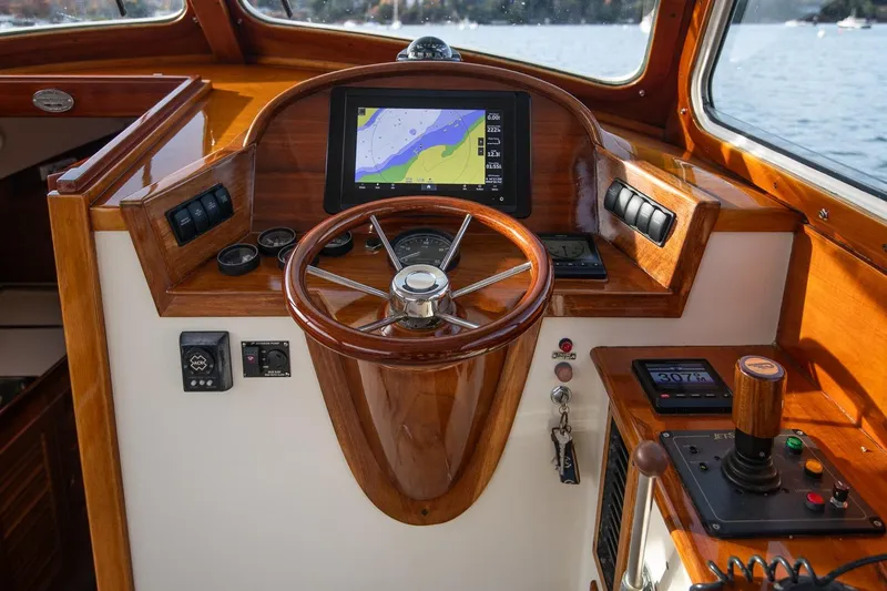 Seaker Yacht Photos Pics 2001 Hinckley Picnic Boat Classic helm with wooden steering wheel and navigation display.