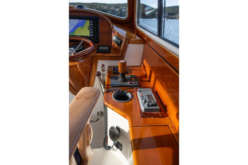 Seaker Yacht Photos Pics 2001 Hinckley Picnic Boat Classic helm with polished wood and navigation controls.