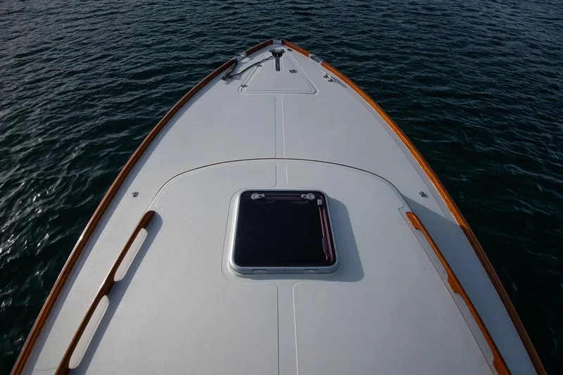 Seaker Yacht Photos Pics 2001 Hinckley Picnic Boat Classic bow on calm water, showcasing elegant design.