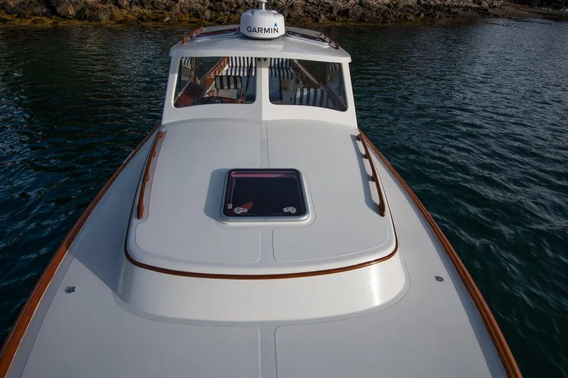 Seaker Yacht Photos Pics 2001 Hinckley Picnic Boat Classic on water, featuring sleek design and Garmin equipment.