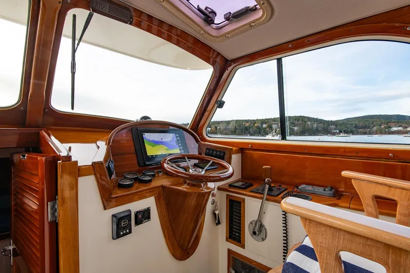 Seaker Yacht Photos Pics 2001 Hinckley Picnic Boat Classic helm with wooden accents and navigation equipment.