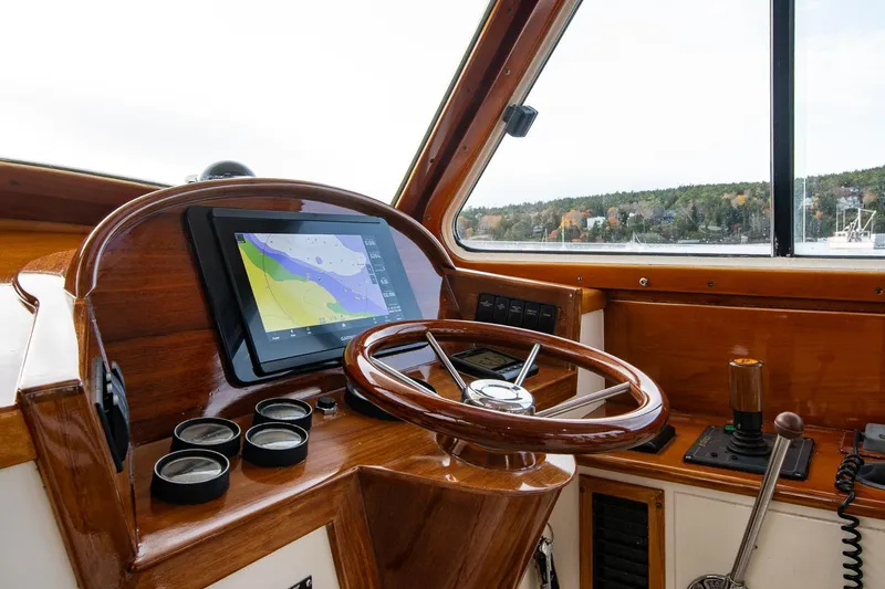 Seaker Yacht Photos Pics 2001 Hinckley Picnic Boat Classic helm with wooden steering wheel and navigation display.