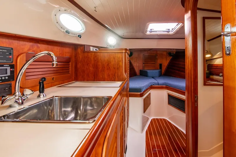 Seaker Yacht Photos Pics Interior of 2001 Hinckley Picnic Boat Classic with wood finish and compact kitchen.