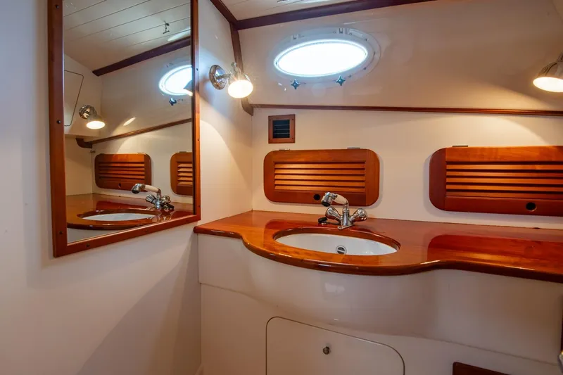 Seaker Yacht Photos Pics Luxurious 2001 Hinckley Picnic Boat Classic bathroom with wooden accents and elegant fixtures.