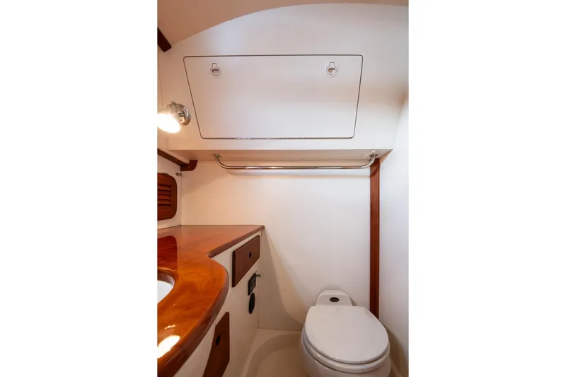 Seaker Yacht Photos Pics 2001 Hinckley Picnic Boat Classic bathroom with wooden accents and compact design.
