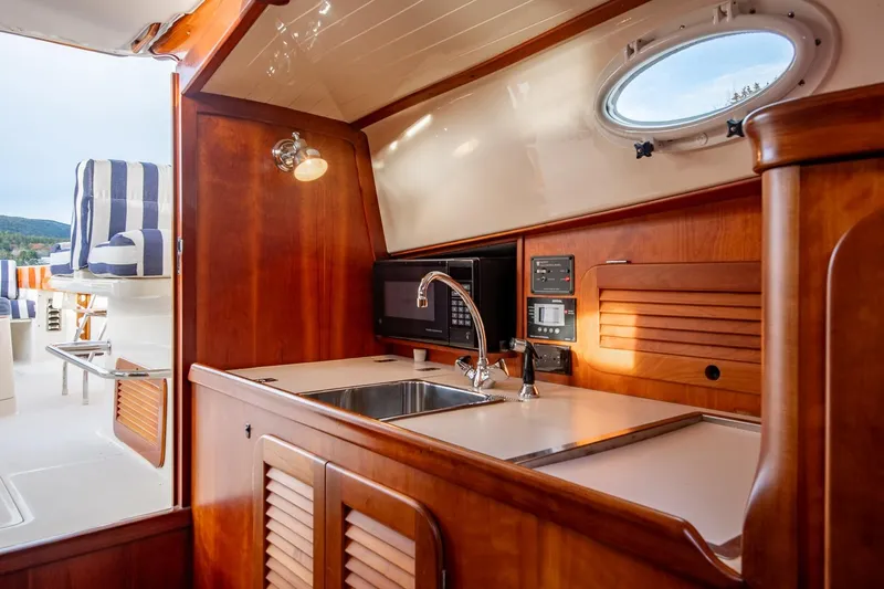 Seaker Yacht Photos Pics 2001 Hinckley Picnic Boat Classic interior with wooden cabinetry and modern amenities.