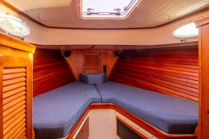 Seaker Yacht Photos Pics 2001 Hinckley Picnic Boat Classic interior with wooden paneling and cozy sleeping area.