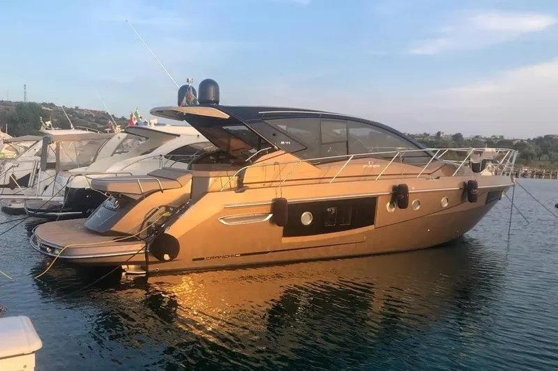  Yacht Photos Pics 2019 Cranchi M 44 HT yacht docked in a marina, side view.