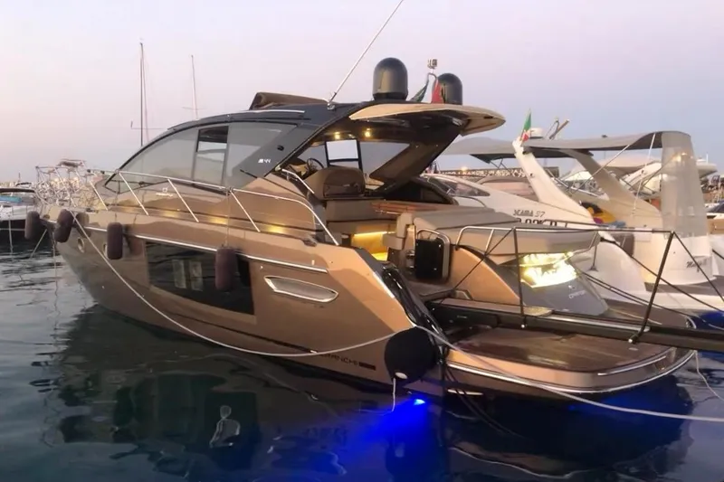  Yacht Photos Pics 2019 Cranchi M 44 HT yacht docked at marina during sunset.