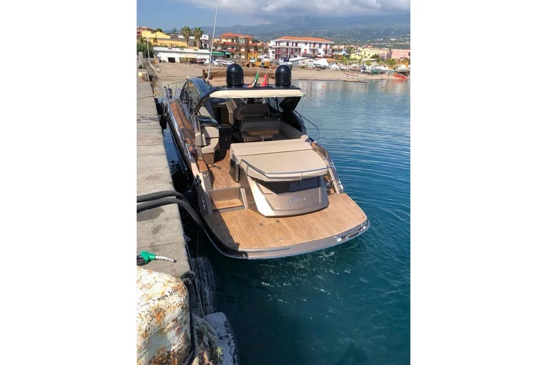  Yacht Photos Pics 2019 Cranchi M 44 HT yacht docked at a marina, showcasing sleek design and luxury features.