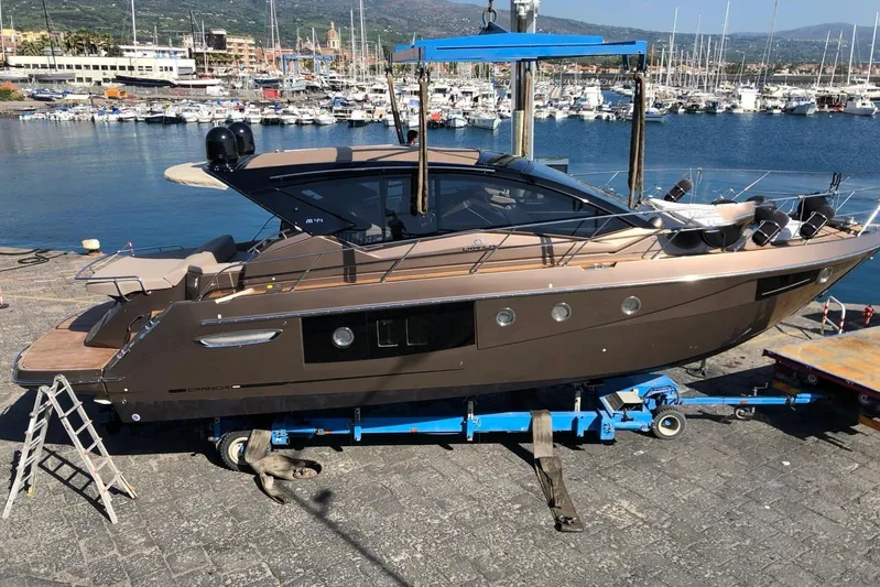  Yacht Photos Pics 2019 Cranchi M 44 HT yacht docked at a marina with scenic harbor view.