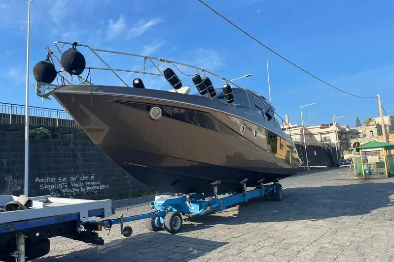  Yacht Photos Pics 2019 Cranchi M 44 HT yacht on trailer, urban setting, clear blue sky.