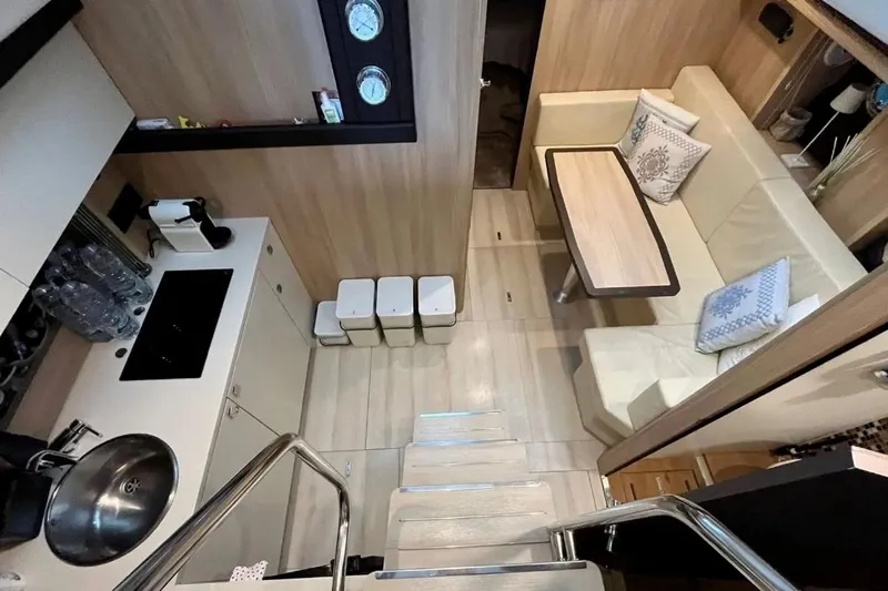  Yacht Photos Pics 2019 Cranchi M 44 HT yacht interior with modern kitchen and cozy dining area.