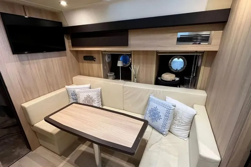  Yacht Photos Pics Luxurious interior of 2019 Cranchi M 44 HT yacht with cozy seating and elegant decor.