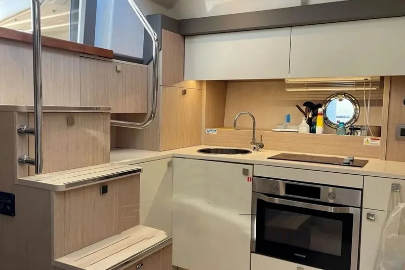  Yacht Photos Pics Modern kitchen interior on 2019 Cranchi M 44 HT yacht, featuring sleek cabinetry and appliances.