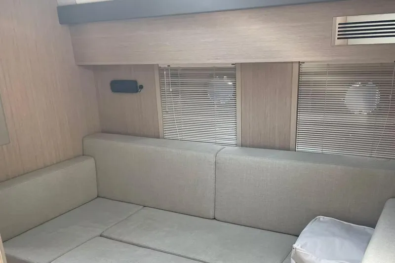  Yacht Photos Pics Interior of 2019 Cranchi M 44 HT yacht with modern seating and porthole windows.