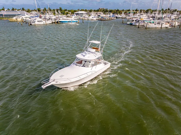  Yacht Photos Pics 2011 Viking 42 Open Yacht in harbor, surrounded by other boats.