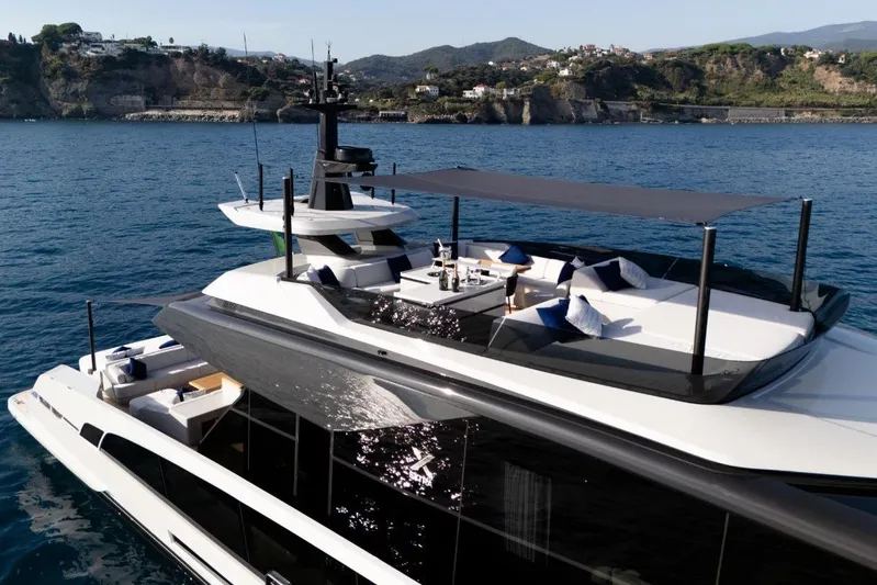  Yacht Photos Pics Luxurious 2025 Extra X90 Fast yacht cruising near scenic coastline.