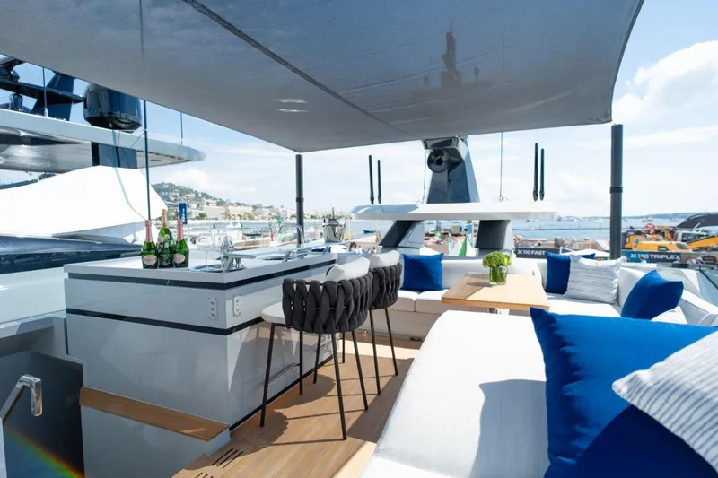  Yacht Photos Pics Luxurious 2025 Extra X90 Fast yacht deck with bar, seating, and ocean view.
