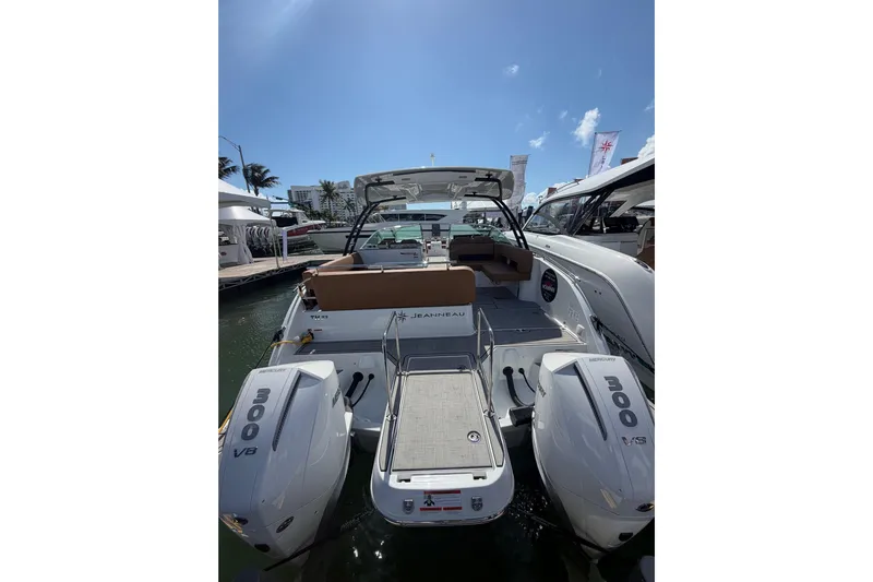  Yacht Photos Pics 2026 Jeanneau TH33 boat with twin 300 HP engines docked under clear blue sky.