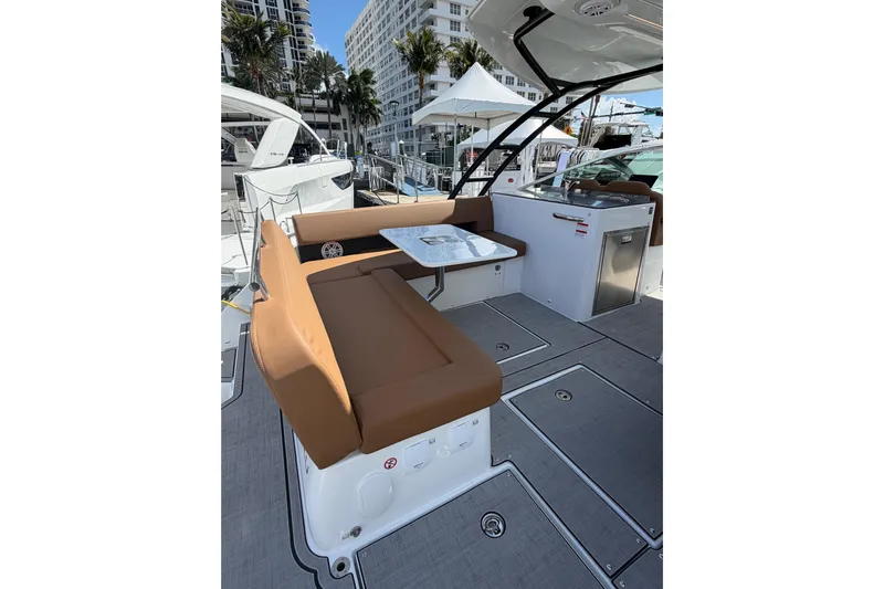 Yacht Photos Pics 2026 Jeanneau TH33 boat interior with brown seating and modern amenities.