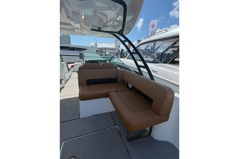  Yacht Photos Pics 2026 Jeanneau TH33 boat interior with brown seating and modern design.