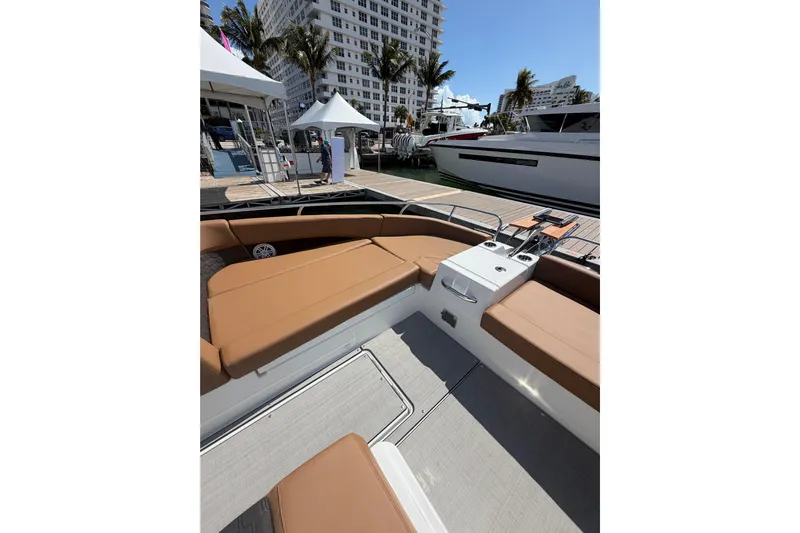  Yacht Photos Pics 2026 Jeanneau TH33 boat interior with tan seating, docked at marina.