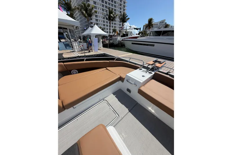  Yacht Photos Pics 2026 Jeanneau TH33 boat interior with tan seating at a marina.