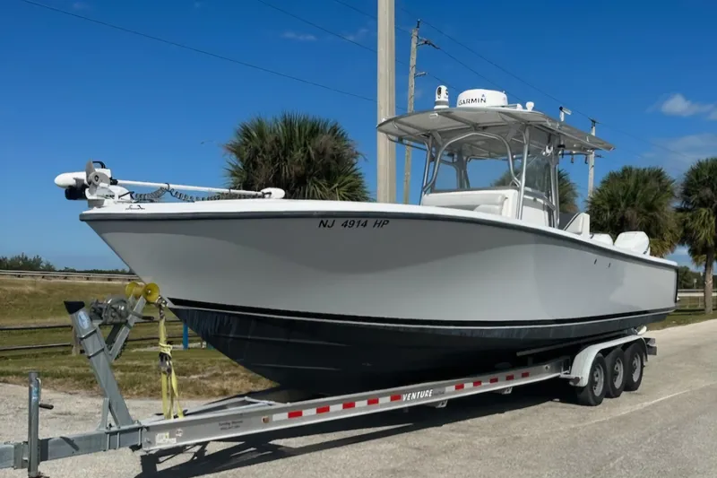  Yacht Photos Pics 2004 SeaVee 340B boat on trailer, parked outdoors under clear blue sky.