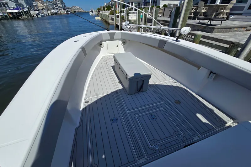  Yacht Photos Pics 2004 SeaVee 340B boat interior with spacious deck and seating, docked by waterfront homes.