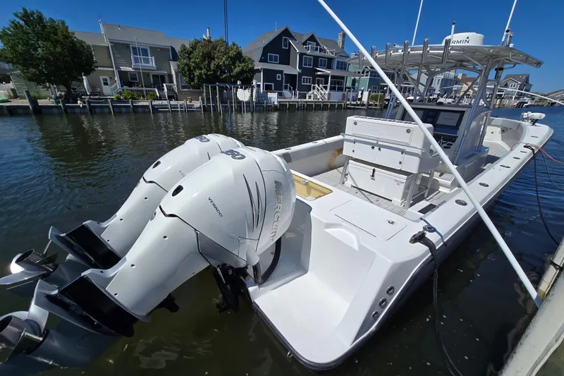  Yacht Photos Pics 2004 SeaVee 340B boat with twin Mercury engines docked in a residential canal.