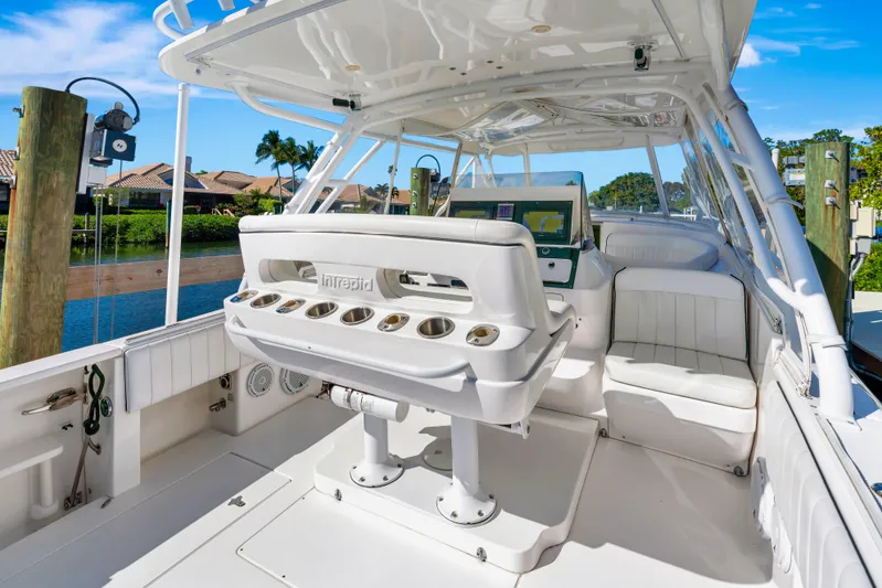  Yacht Photos Pics 2012 Intrepid 400 Cuddy boat interior with seating and helm, docked by waterfront homes.